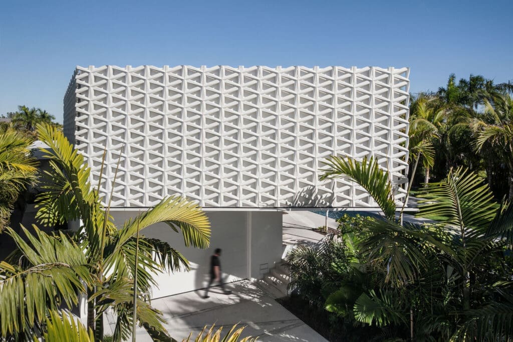 Perforated concrete screen at Morningside Residence filtering daylight into the courtyard