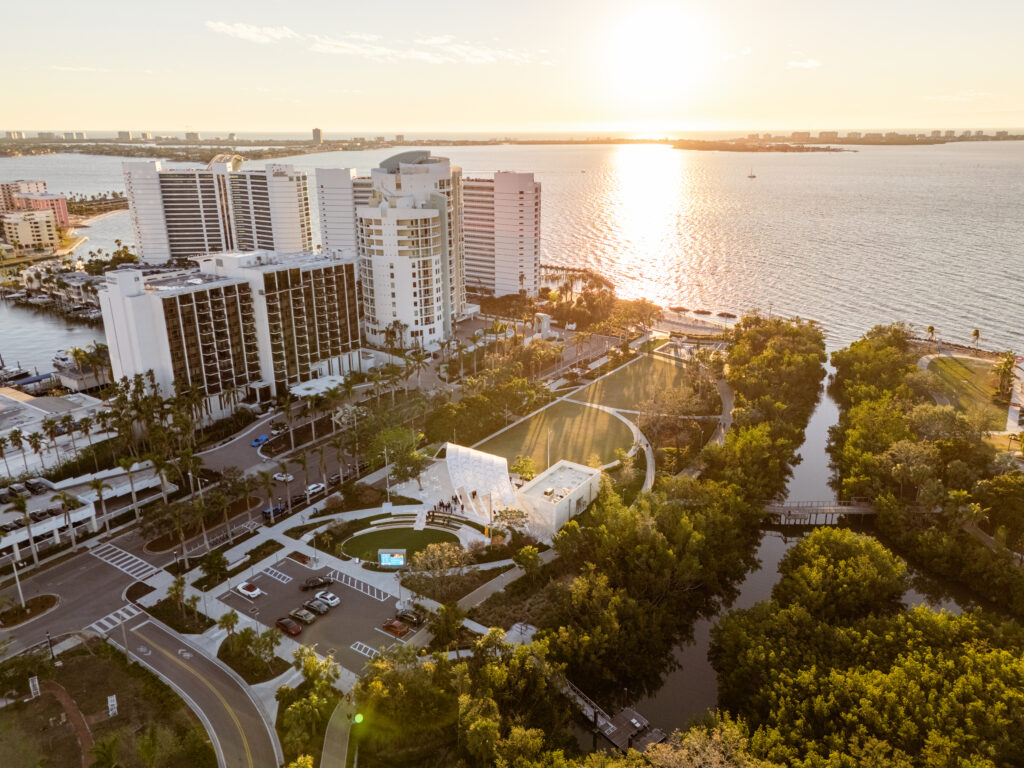 Drone photo of The Bay, city and water around the park at sunset. 